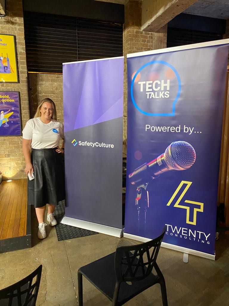 Tech Talks banner alongside a host at a SafetyCulture-hosted 4Twenty event